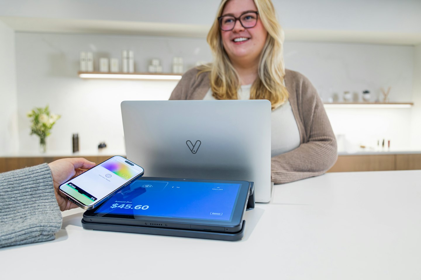 Customer pays with a smartphone at a retail terminal.